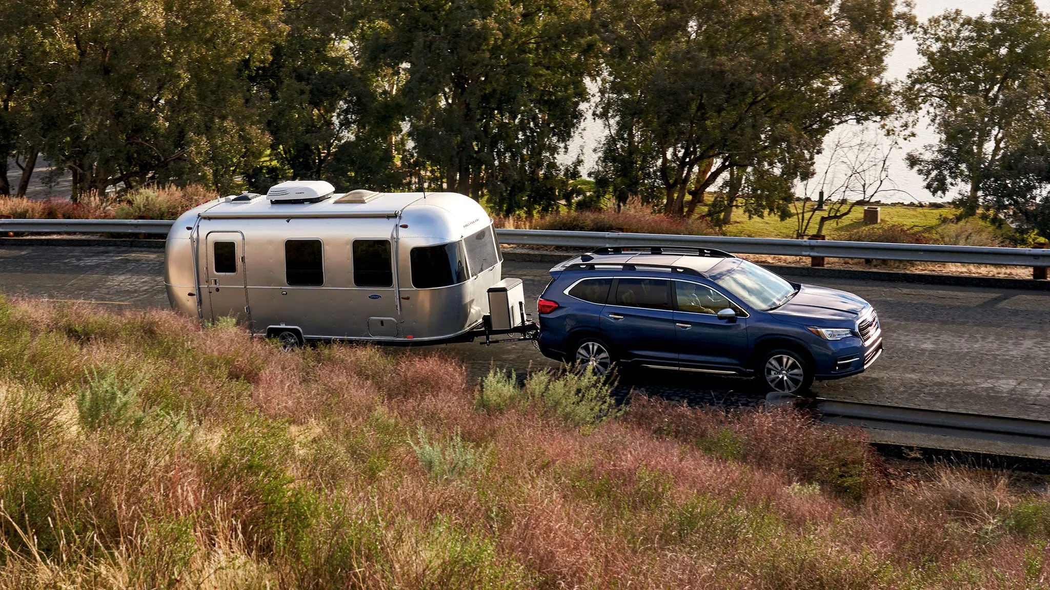 Subaru Ascent SUV towing a recreational trailer on the open highway